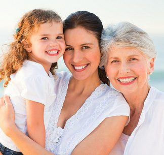 Ladies of three generation wearing white attire